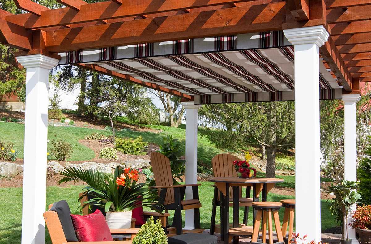 EZ canopy pergola with retractable striped fabric shade, paired with poly outdoor furniture—provides stylish sun protection for backyard entertaining.