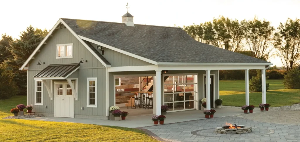 Custom Lexington pavilion-style garage and outdoor living structure by Salem Structures featuring a covered patio, overhead door, and landscaped fire pit area