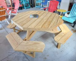 Wooden octagon picnic table with attached benches on display at Salem Structures, perfect for outdoor dining, parks, and backyard entertaining.