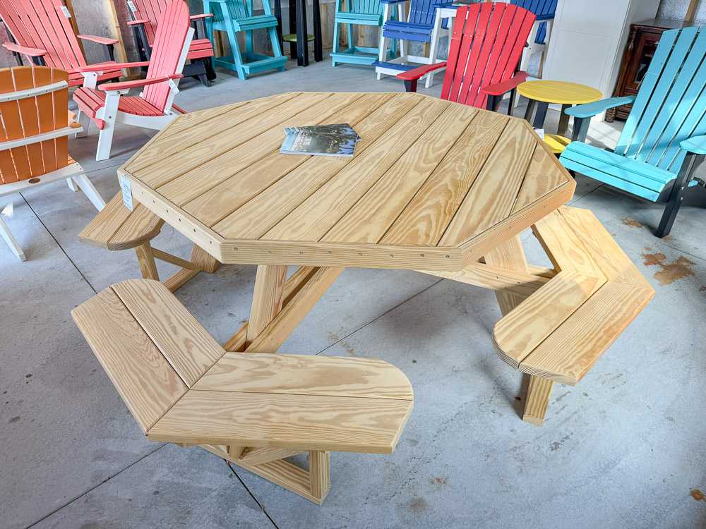 Wooden octagon picnic table with attached benches on display at Salem Structures, perfect for outdoor dining, parks, and backyard entertaining.