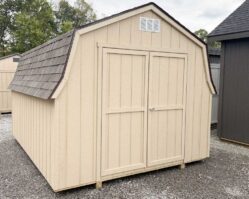 Tan mini barn storage shed from Salem Structures featuring shingle roof, double doors, and classic barn-style roofline.
